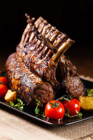 Baked lamb loin, served with asparagus. Dark background.の写真素材