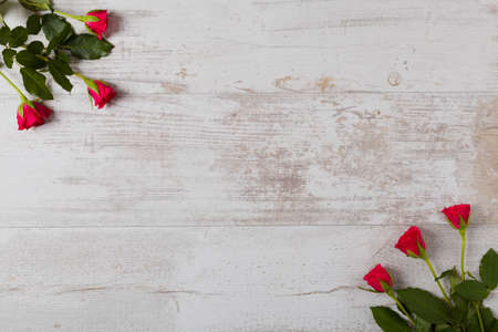 Valentine's Day. Roses on white wooden background.