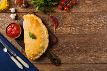 Italian calzone with mushrooms and ham. Top view.の写真素材