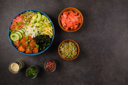 Hawaiian salmon poke bowl with seaweed, avocado, sesame seeds.
