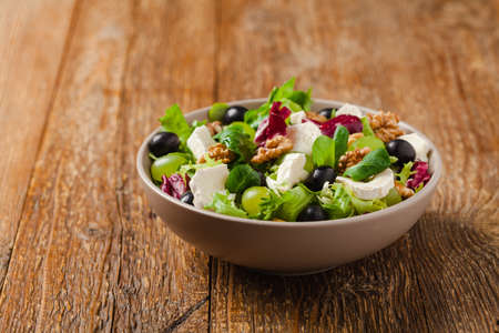 Italian spring salad with goat cheese, grapes and walnuts. Served with croutons.の写真素材