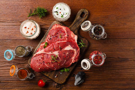 Raw beef steak, ready for grilling. Grill accessories. Concept. Free space for description. Top...