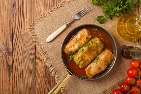 Traditional stuffed cabbage with minced meat and rice, served in a tomato sauce. Top view. Flat lay.の写真素材
