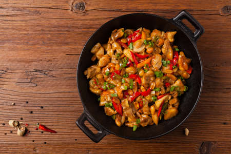 Kung pao chicken. Fried chicken pieces with peanuts and peppers. Top view. Flat lay.の写真素材