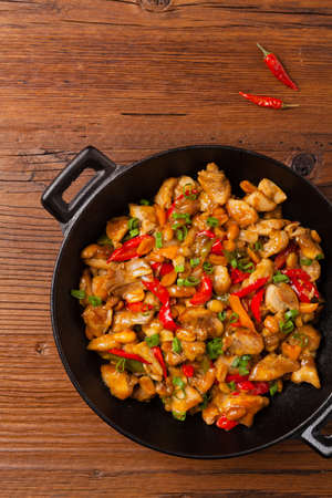 Kung pao chicken. Fried chicken pieces with peanuts and peppers. Top view. Flat lay.の写真素材