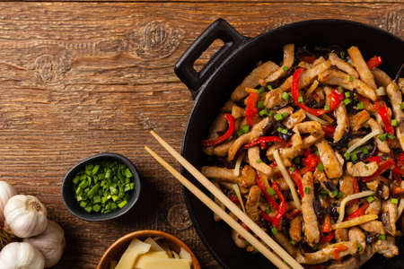 Pork chop with peppers, mushrooms and bamboo. Served with rice. Top down.の写真素材
