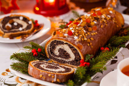 Poppy seed roulade in Christmas decoration. Served with coffee or tea. Front view.の写真素材