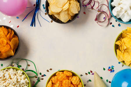 Background with snacks, balloons, party hat, confetti. Perfect for a party. Top view.