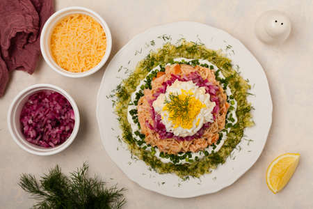 Traditional Russian Mimosa salad with salmon cheese and potatoes. Top view