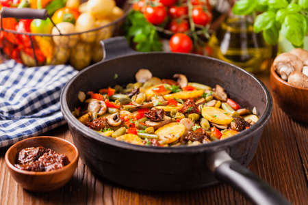 Fried pan vegetables, with mushrooms and dried tomatoes. Seasoned with a mix of herbs.
Top view.の写真素材