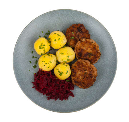 Minced meat cutlets, served with boiled potatoes and beets on a gray plate. White background. Pack...