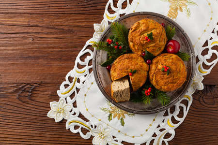 Small, baked patties in Christmas retro styling. Top view. Natural wooden background.の写真素材