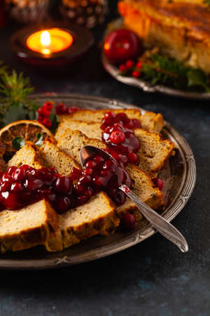 Delicious chicken and pork pate in Christmas decoration. Rustic style. Dark background, metal plates. Front view.の写真素材