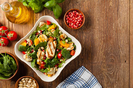 Traditional Greek salad with grilled Halloumi cheese with basil. Top view. Flat lay.の写真素材