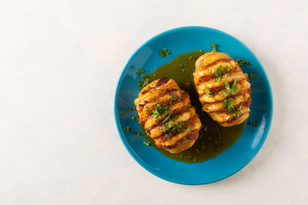 Baked potatoes in Swedish. Hasselback. Stuffed with cheese and bacon. Top view.