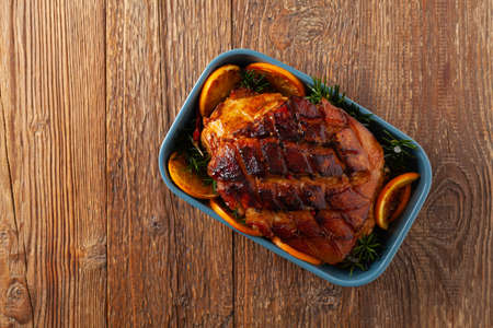 Whole baked ham. Cut thick skin. Marinated in oranges and honey. Top view.の写真素材