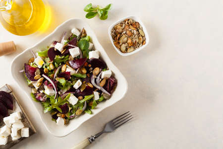 Vegetarian salad with beets and feta. Served in a square bowl. Top view.の写真素材