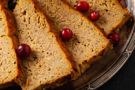 Delicious chicken and pork pate in Christmas decoration. Rustic style. Dark background, metal plates. Front view.の写真素材