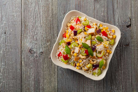 Salad with rice, chicken, peanuts and vegetables. Top view.の写真素材