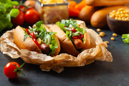 Vegetarian hot dogs with soy sausages and fresh vegetables. Front view.の写真素材