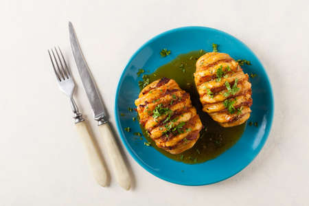 Baked potatoes in Swedish. Hasselback. Stuffed with cheese and bacon. Top view.