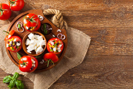 Greek stuffed tomato with feta cheese, olives, and fresh pepper. Top view.の写真素材