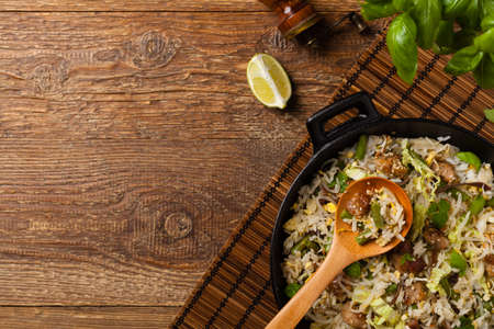 Fried veal, with rice, Chinese cabbage and mushrooms. Sprinkled with sesame and soy sauce. Top view.の写真素材
