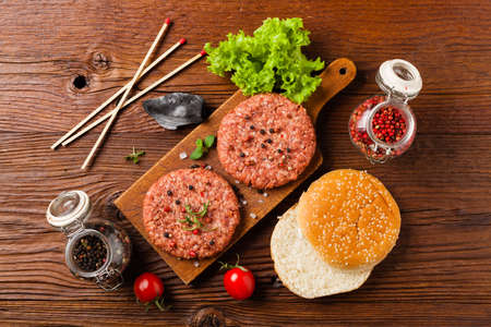 Raw beef burger, ready for grilling. Grill accessories. Concept. Free space for description. Top view.の写真素材