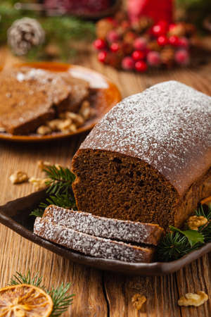 Homemade gingerbread cake. Christmas decoration. Front view. Natural wooden background.の写真素材