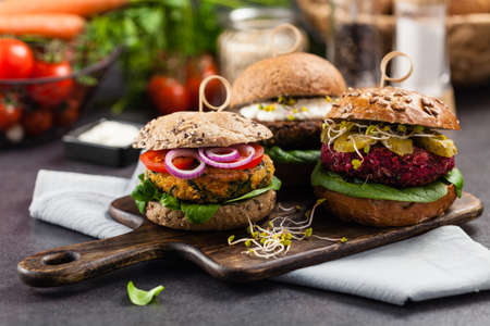 Vege burgers with carrots, beetroots and mushrooms. Front view. Black background.の写真素材