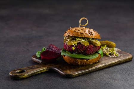 Vege burgers with carrots, beetroots and mushrooms. Front view. Black background.の写真素材