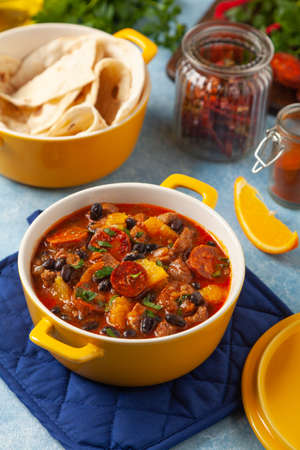 Pork stew with chorizo and black beans. Served with orange and seasoned with hot chili peppers. Perfect with tortillas.の写真素材