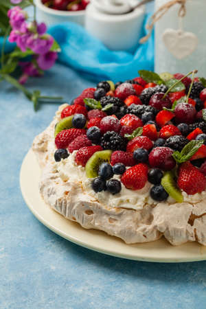 Meringue Pavlova cake with fresh fruit. Front view.の写真素材