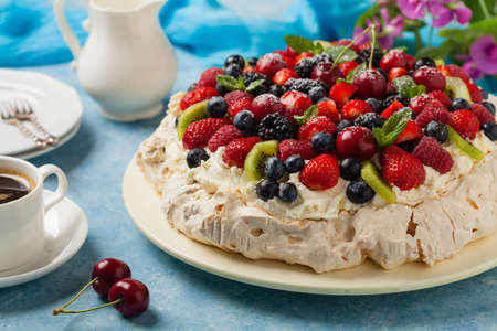 Meringue Pavlova cake with fresh fruit. Front view.の写真素材