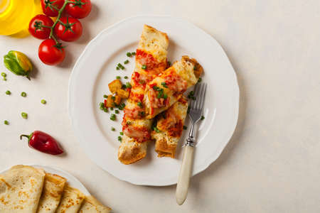 Baked pancakes with chicken in tomato sauce. Top view.の写真素材