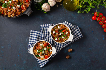 Traditional Greek cuisine. Lamb stew with feta cheese and vegetables. Dark background.の写真素材
