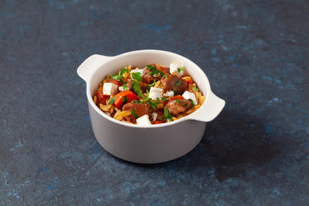 Traditional Greek cuisine. Lamb stew with feta cheese and vegetables. Dark background.の写真素材