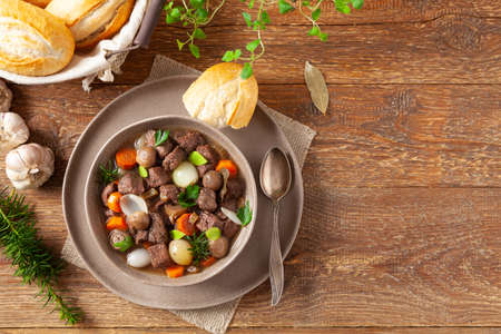 Classic burgundy goulash. Wooden background.の写真素材