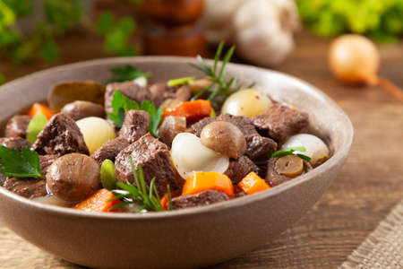 Classic burgundy goulash. Wooden background.の写真素材
