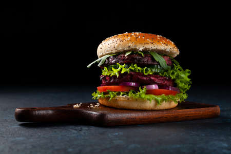 Vegetarian burger. Dark mood. Black background.の写真素材