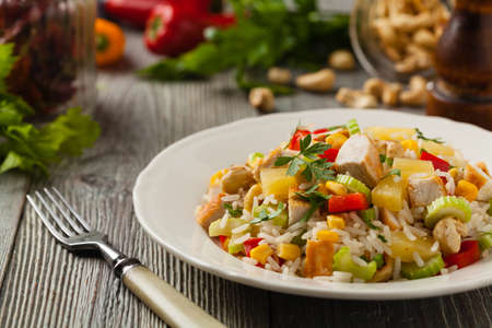 Salad with rice, chicken, peanuts and vegetables. Front view.の写真素材