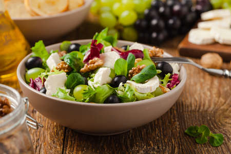 Italian spring salad with goat cheese, grapes and walnuts. Served with croutons.の写真素材