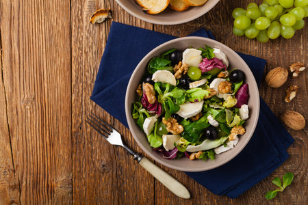 Italian spring salad with goat cheese, grapes and walnuts. Served with croutons. Top view.の写真素材