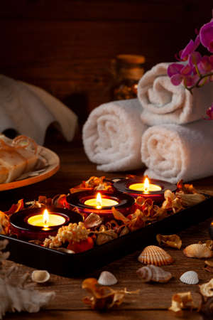 SPA accessories. Scented candles, shells, towels and bath salts. Candles and an intimate atmosphere.の写真素材