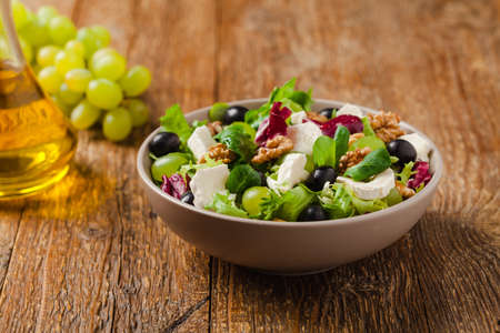 Italian spring salad with goat cheese, grapes and walnuts. Served with croutons.の写真素材