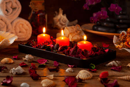 SPA accessories. Scented candles, shells, towels and bath salts. Candles and an intimate atmosphere.の写真素材