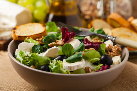 Italian spring salad with goat cheese, grapes and walnuts. Served with croutons.の写真素材