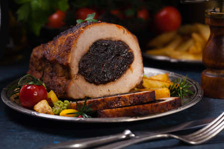 Whole roasted pork loin stuffed with dried plum.の写真素材