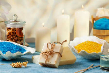 SPA accessories. Scented candles, shells, towels and bath salts. Candles and an intimate atmosphere.の写真素材