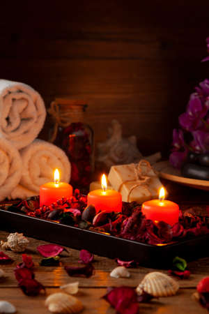 SPA accessories. Scented candles, shells, towels and bath salts. Candles and an intimate atmosphere.の写真素材